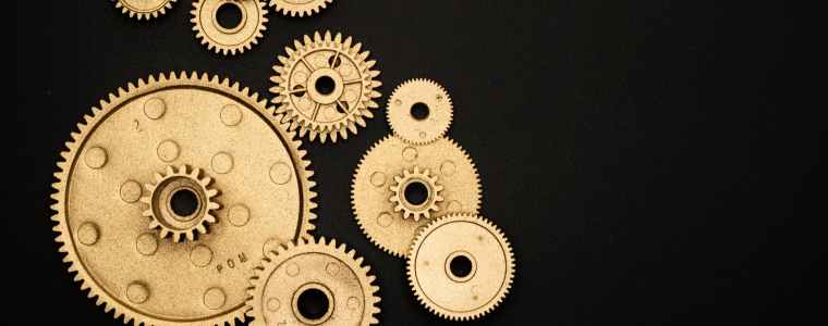 photo of golden cogwheel on black background