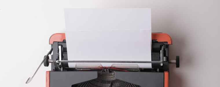 writer working on typewriter in office